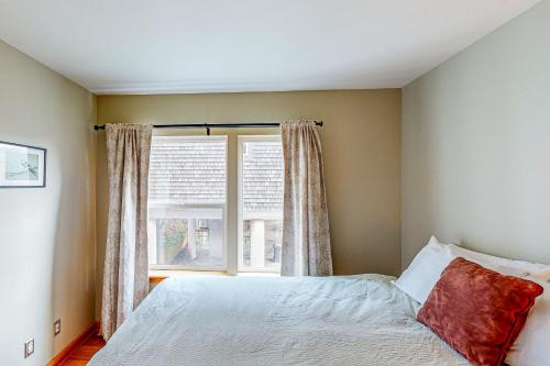 a bedroom with a bed and a window at Netarts Bay and Ocean Views in Netarts