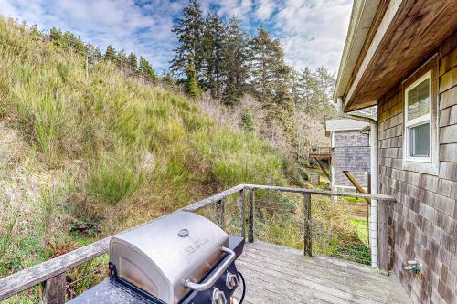a grill sitting on a porch of a house at Netarts Bay and Ocean Views in Netarts