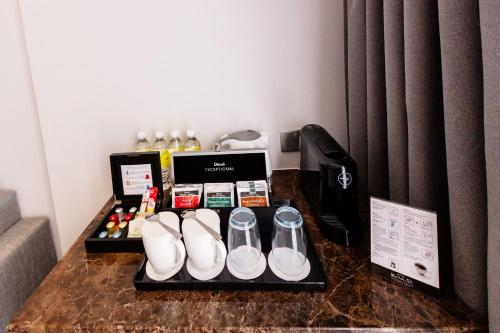 a table with a tray with shoes and other items at Holiday Inn Sepang - Airport in Sepang