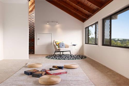 a living room with a chair and a table at 3BR The Vintage Loft Unique Charm &Modern Comfort in Springwood