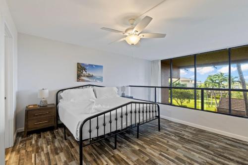 a bedroom with a bed and a ceiling fan at Kahana Villa F208- Ocean view spacious 2 bedroom across from beach in Lahaina