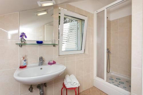 a bathroom with a sink and a shower at Apartments Marija in Zaton