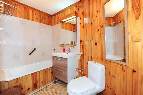 a bathroom with a toilet and a sink and a tub at Appartement charmant à Les Menuires, 36 m², vue montagne. in Saint-Martin-de-Belleville