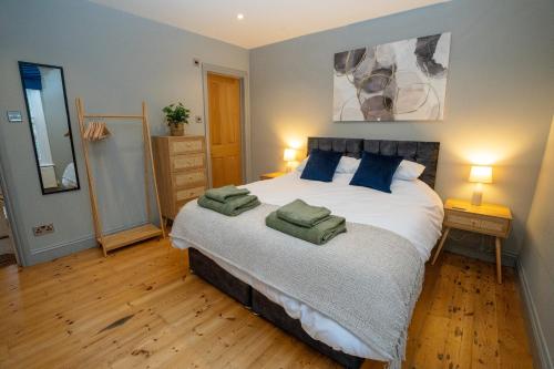 a bedroom with a large bed with blue pillows at 4 Bedroom Winchester Town House, central, parking in Winchester