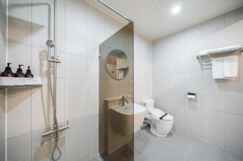 a bathroom with a shower and a toilet at The 7 Business Hotel in Gumi