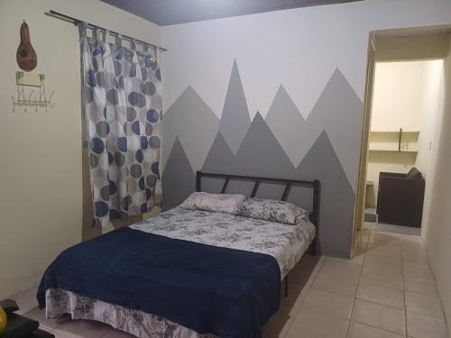 a bedroom with a bed and a wall with mountains at Residência Dazzi in Rio de Janeiro