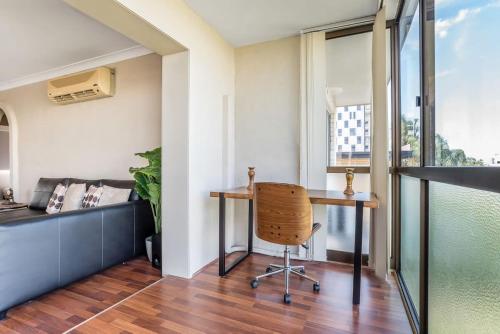 an office with a desk and a chair in a room at Tranquil Arches Indooroopilly in Brisbane