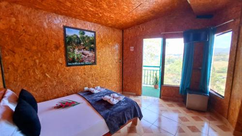 a bedroom with a bed and a painting on the wall at Refugio Ecolodge Shapingo in Moyobamba
