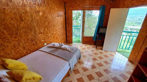 a bedroom with a bed and a large window at Refugio Ecolodge Shapingo in Moyobamba