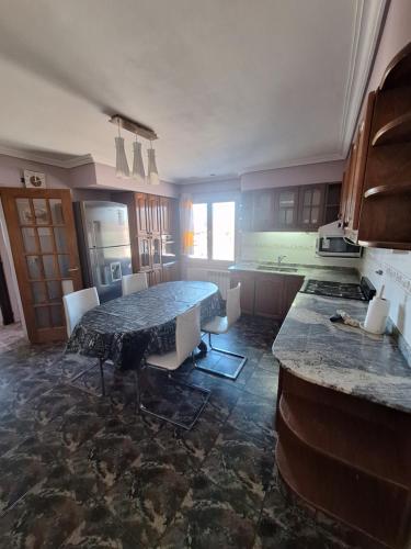 a kitchen with a table and chairs in a room at Departamento Emanuel in Comodoro Rivadavia