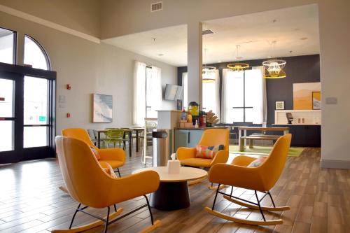 a lobby with chairs and a table in a building at Spark By Hilton Albuquerque North I-25 in Albuquerque