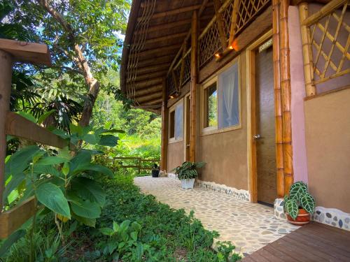 a house with a walkway next to a building at Aracari Ecolodge in San Rafael