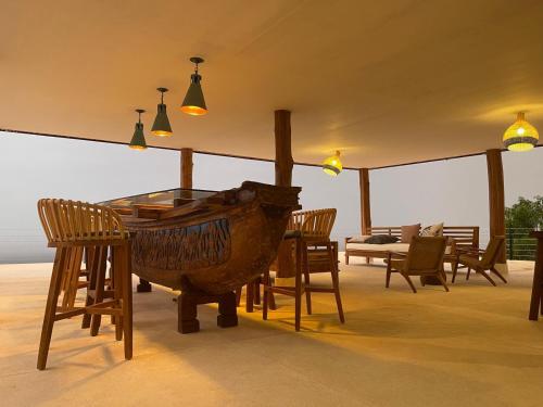 a room with a table and chairs and lights at Villa Salama in Tanjung