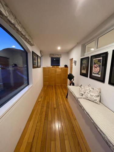 a living room with a large window and wooden floors at Perano Penthouse in Picton