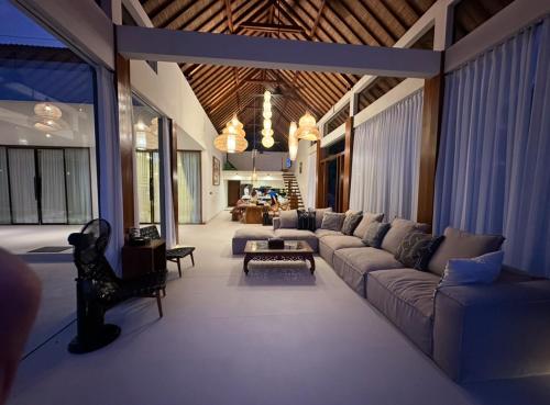 a living room with a couch and a table at Villa Salama in Tanjung