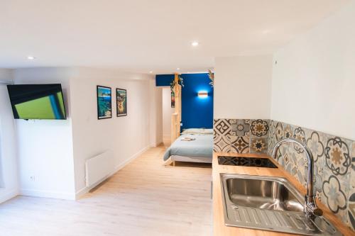 a kitchen with a sink and a bed in a room at - Apparts nets à prix honnête - in Brest