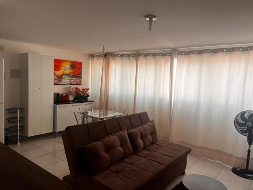 a living room with a couch and a glass table at Smart & Comfort 3 - Ap completo in João Pessoa