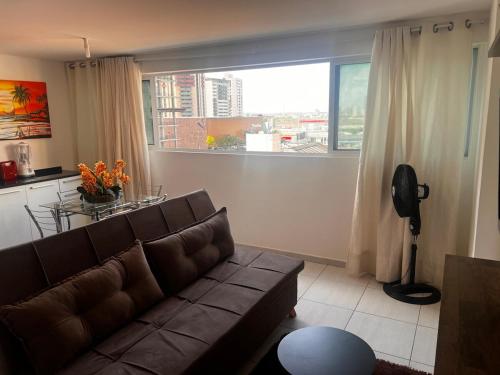 a living room with a couch and a large window at Smart & Comfort 3 - Ap completo in João Pessoa
