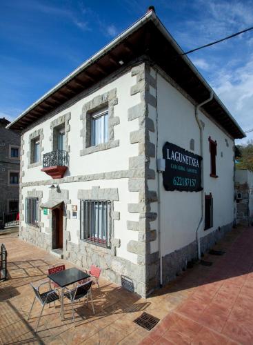 a building with a sign on the side of it at Casa Rural Lagun Etxea in Pobes