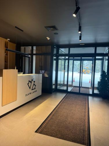 an office with a lobby with glass doors and a rug at Zlatni Javor 211 in Jahorina