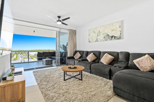 a living room with a couch and a table at Harbour Quays Apartments in Gold Coast