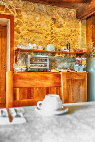 a kitchen with a counter with a toaster oven at A Casa do Folgo Turismo Rural in Negreira
