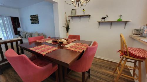 a dining room with a table and red chairs at Spacious 2BR 2BA Suite - Walk to Mall & Hospitals in Gainesville