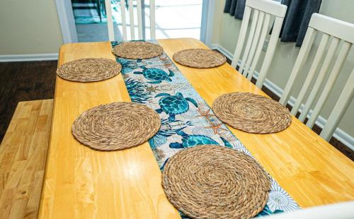 a wooden table with four wooden hats on it at Spacious home with heated pool in Palm Coast! in Palm Coast