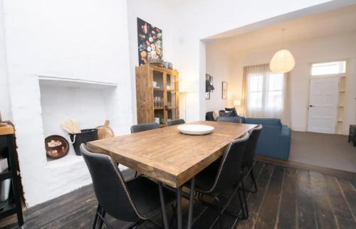 a dining room with a wooden table and chairs at The Paddington Bathurst #8 in Bathurst