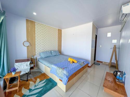 a bedroom with a bed with a stuffed animal on it at Long Vĩ hotel - đảo Phú Quý in Cu Lao Thu