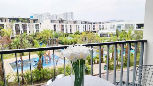 a vase with white flowers on a table on a balcony at YLY Lotus in Ha Long