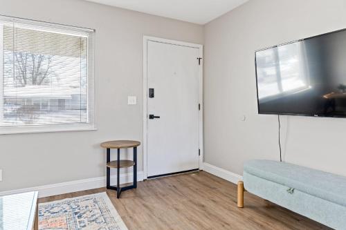a living room with a couch and a flat screen tv at Newly Renovated 3 Bedroom St. Peters MO Home in Cottleville