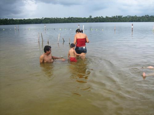a woman and two people in the water at Antares Jungle Lodge in Miraflores