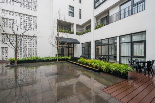 a courtyard in a building with a table and chairs at Cendre Hotel (Lingering Garden and Tiger Hill) in Suzhou