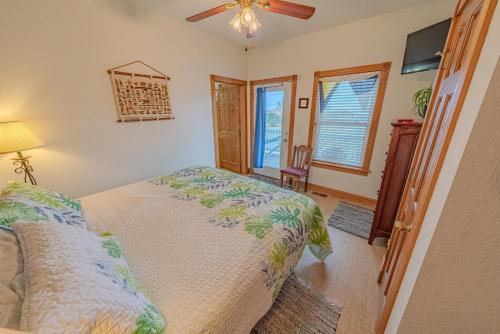 a bedroom with a bed and a ceiling fan at Frolic Inn OBX - Semi Soundfront Retreat, Pool, Hot Tub, Boat Ramp, Elevator, Media & Game Room in Rodanthe