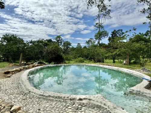 a pool with blue water in a yard at Casa Lajas - Casa 1 - Hospedaje, Granja y Turismo Rural in Turrialba