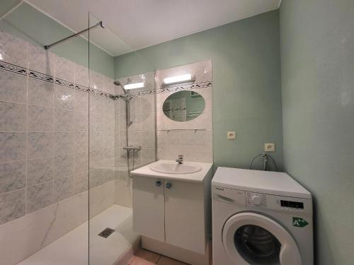 une salle de bain avec une machine à laver et un lave-linge dans l'établissement Appartement 2 pers à St Brevin les Pins, 50m plage, balcon, parking, proche commerces - FR-1-364-163, à Saint-Brévin-les-Pins