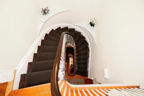 a stairway with a spiral staircase in a building at Charming & Stylish Studio on Beacon Hill #3 in Boston