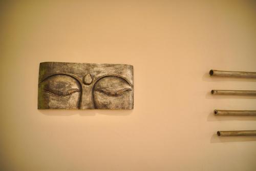 a painting of a mask on a wall at Villa Seruni Lovina in Lovina