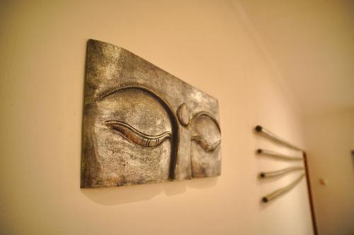a metal artifact hanging on a wall at Villa Seruni Lovina in Lovina