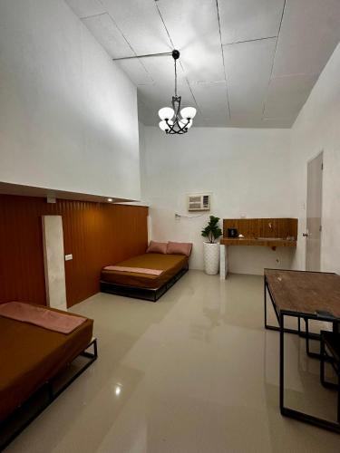 a room with a couch and a bed in it at Bgs Place Moalboal in Moalboal