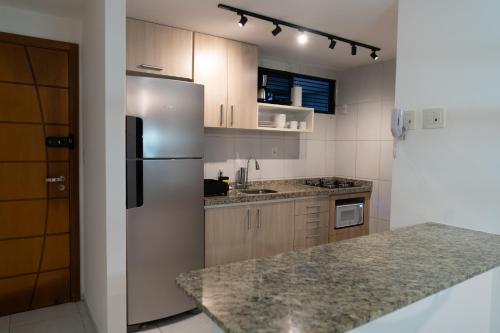 a kitchen with a refrigerator and a counter top at Paraíso em Tambauzinho in João Pessoa