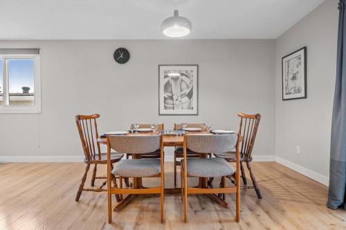 a dining room with a wooden table and chairs at Comfy, Cozy, Central Calgary, 2BR and 1BTH in Calgary