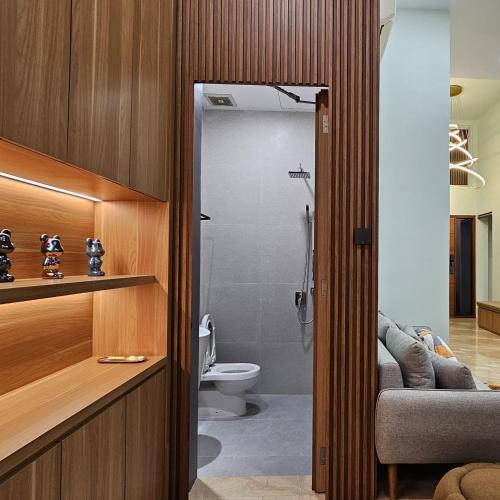 a bathroom with a toilet and a shower in a room at 3 Bedroom House Near Grand Batam Mall in Bagam