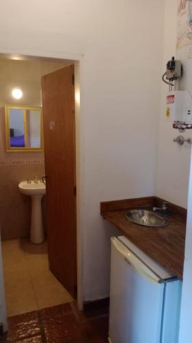 a small bathroom with a sink and a toilet at Cabañas Sol de las Sierras in Tandil