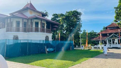 a person standing in front of a house at Sunrise City Bliss in Sri Jayewardenepura Kotte