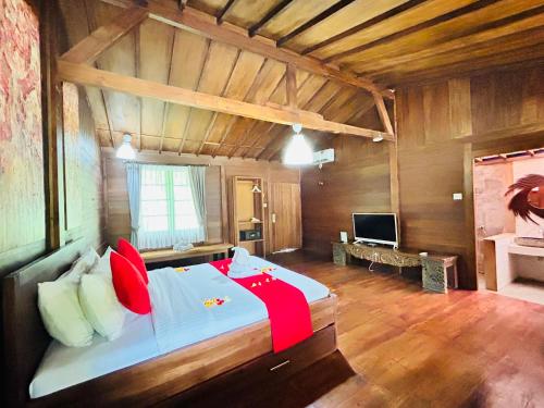 a bedroom with a large bed in a room at Avery Coconut Island Waterpark Beach Resort Carita in Carita