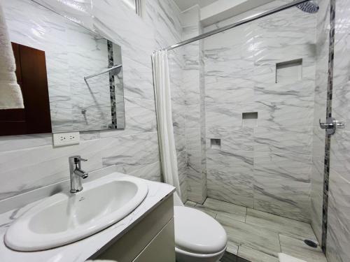 a bathroom with a shower and a sink and a toilet at Andes Retreat 5 Bedroom 3 Bath in Baños