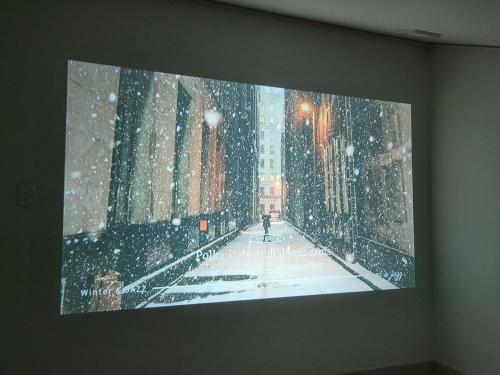 a picture of a city in the snow on a wall at Bongbong Stay in Seoul