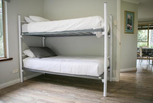 a couple of bunk beds in a room at Bettenays Margaret River in Metricup